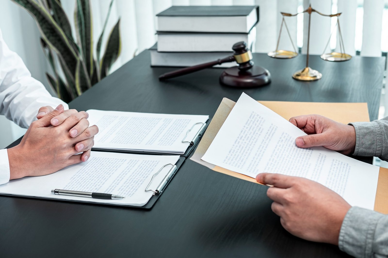 male-lawyer-discussing-negotiation-legal-case-with-client-meeting-with-document-contract-in-office-1.jpg